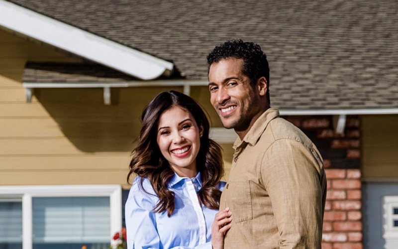 Couple in front of home